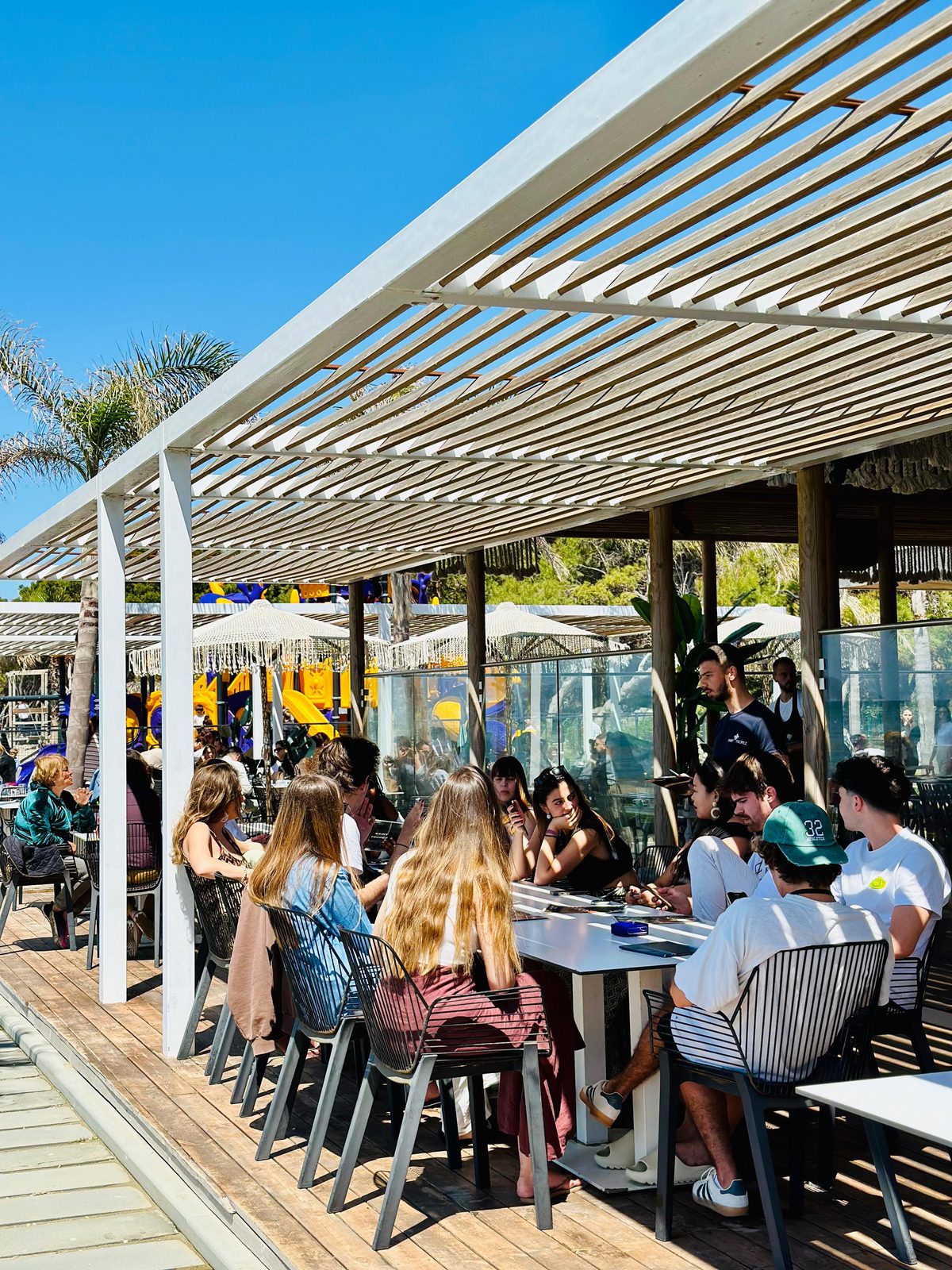 Lively afternoon gathering on the Saint Tropez outdoor pergola terrace